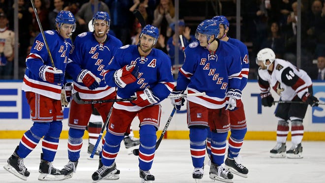 New York Rangers defenseman Dan Girardi (5) celebrates with teammates after scoring a goal during the third period against the Arizona Coyotes at Madison Square Garden.