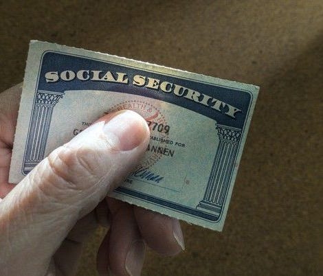Fingers holding a Social Security card