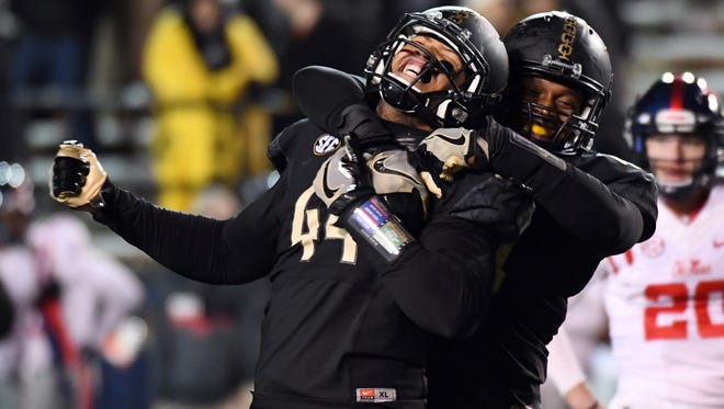 Vanderbilt defensive lineman Nehemiah Mitchell celebrates with teammate Jonathan Wynn after a defensive stop against Mississippi.