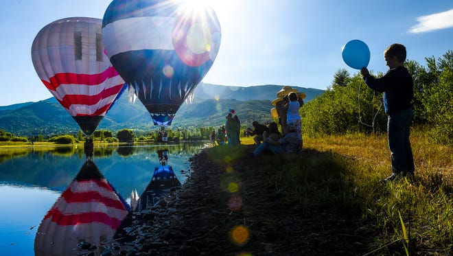Crowds gather at Bald Eagle Lake to watch hot air balloons take off at the Hot Air Balloon Rodeo in Steamboat Springs, CO. 