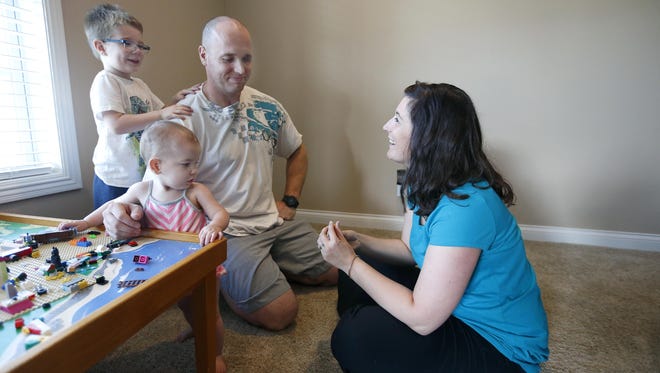 Aaron and Amanda Pearson play with their two kids Jack, 3, and Jovi, 1, in their basement on Thursday, July 30, 2015. Family time has become more important than ever after Aaron was shot. "We have a lot more family time and hanging out with the kids. WeÕre just trying to make lots of little moments with them,Ó Amanda said.