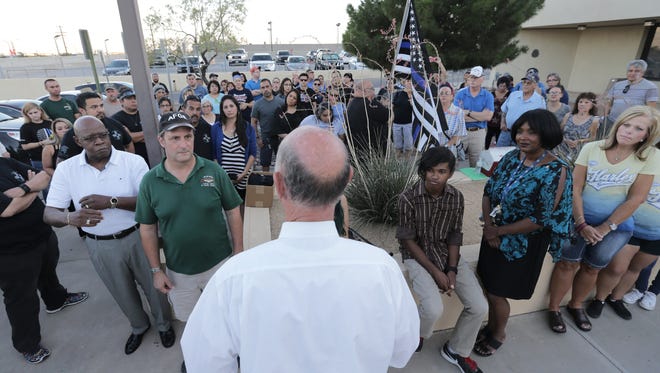 Former El Paso Mayor John Cook talks to a group of people who gathered outside the El Paso Police Department Headquarters to pray for police officers Thursday.