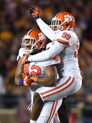 Clemson defensive linemen Christian Wilkins (42) and Clelin Ferrell (99) celebrate after Wilkins sacked Boston College quarterback Patrick Towles (8) during the 2nd quarter at Boston College's Alumni Stadium in Chestnut Hill, Mass. on Friday.