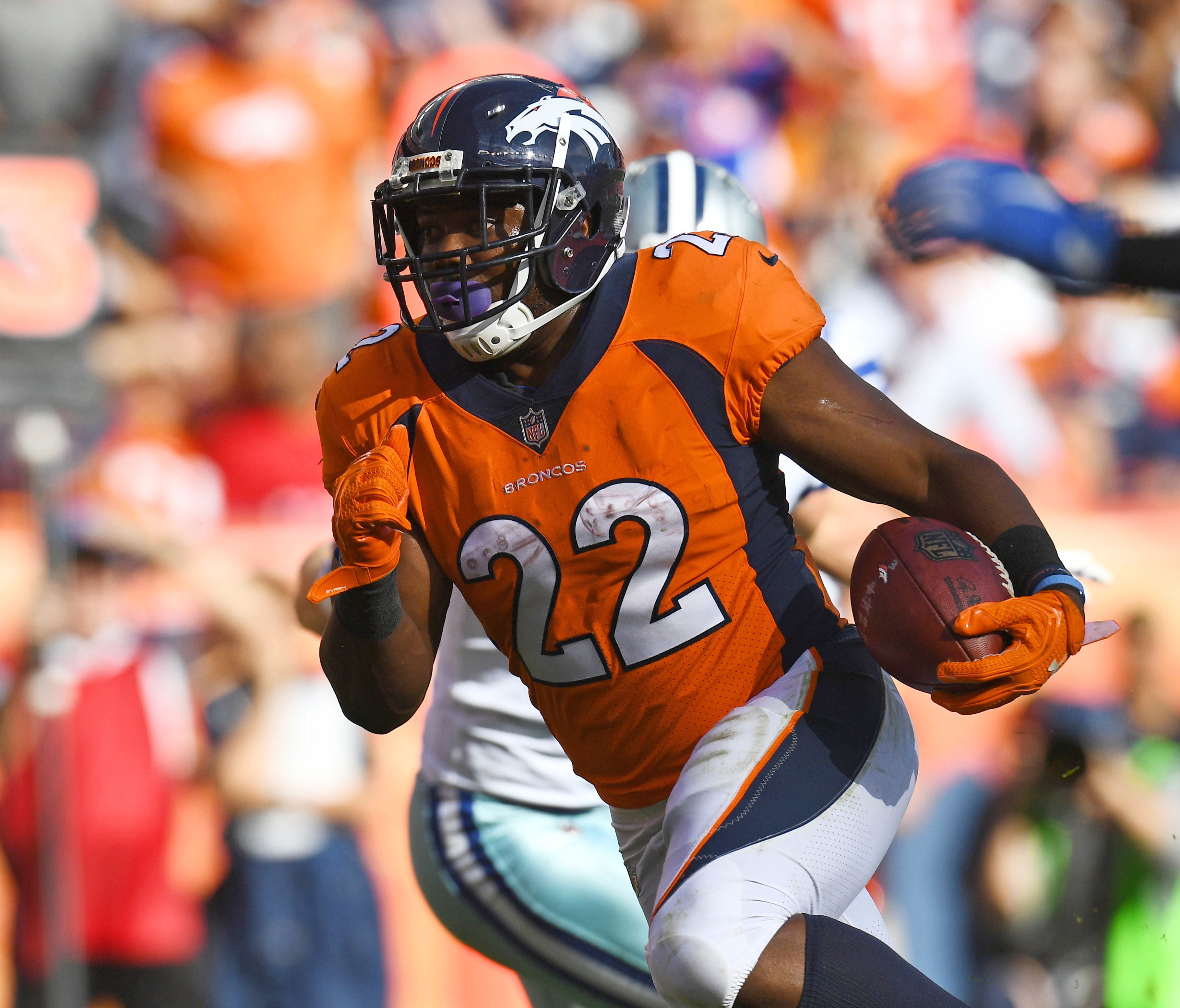 Denver Broncos running back C.J. Anderson (22) carries the ball in the second quarter against the Denver Broncos at Sports Authority Field at Mile High.
