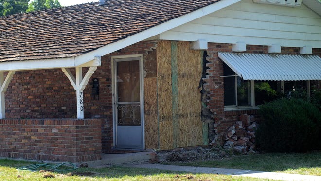 A section of a home in the 700-block of Kirman Avenue near Midtown is boarded up after a driver was accused of ramming his car into the brick house early Monday morning.