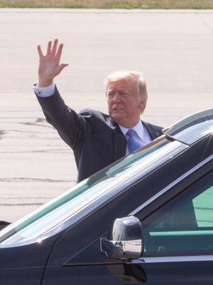 U.S. President Donald Trump waves to well-wishers gathered for his arrival at Indianapolis International Airport, Indianapolis, Wednesday, Sept. 27, 2017. Trump is scheduled to speak at the Indiana Fair Grounds later in the afternoon. 