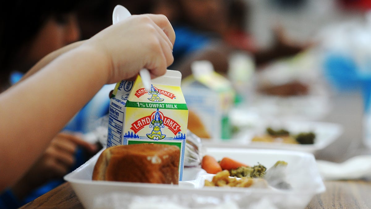 A student at Terry Redlin Elementary School opens his milk carton during lunch on Thursday, Aug. 21, 2014, at Terry Redlin Elementary School, which is participating in the Community Eligibility Provision, in Sioux Falls, S.D. The Community Eligibility Provision, which was approved as part of the 2010 Healthy and Hunger Free Kids-Act, took effect this year, and allows all students at participating schools or programs to   eat free breakfast and lunch. Nine schools in the Sioux Falls School District are participating in the program.