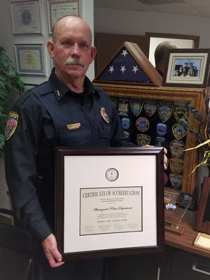 Alamogordo Police Department Acting Police Chief Roger Schoolcraft hold the departments accreditation certificate while in his office Thursday.