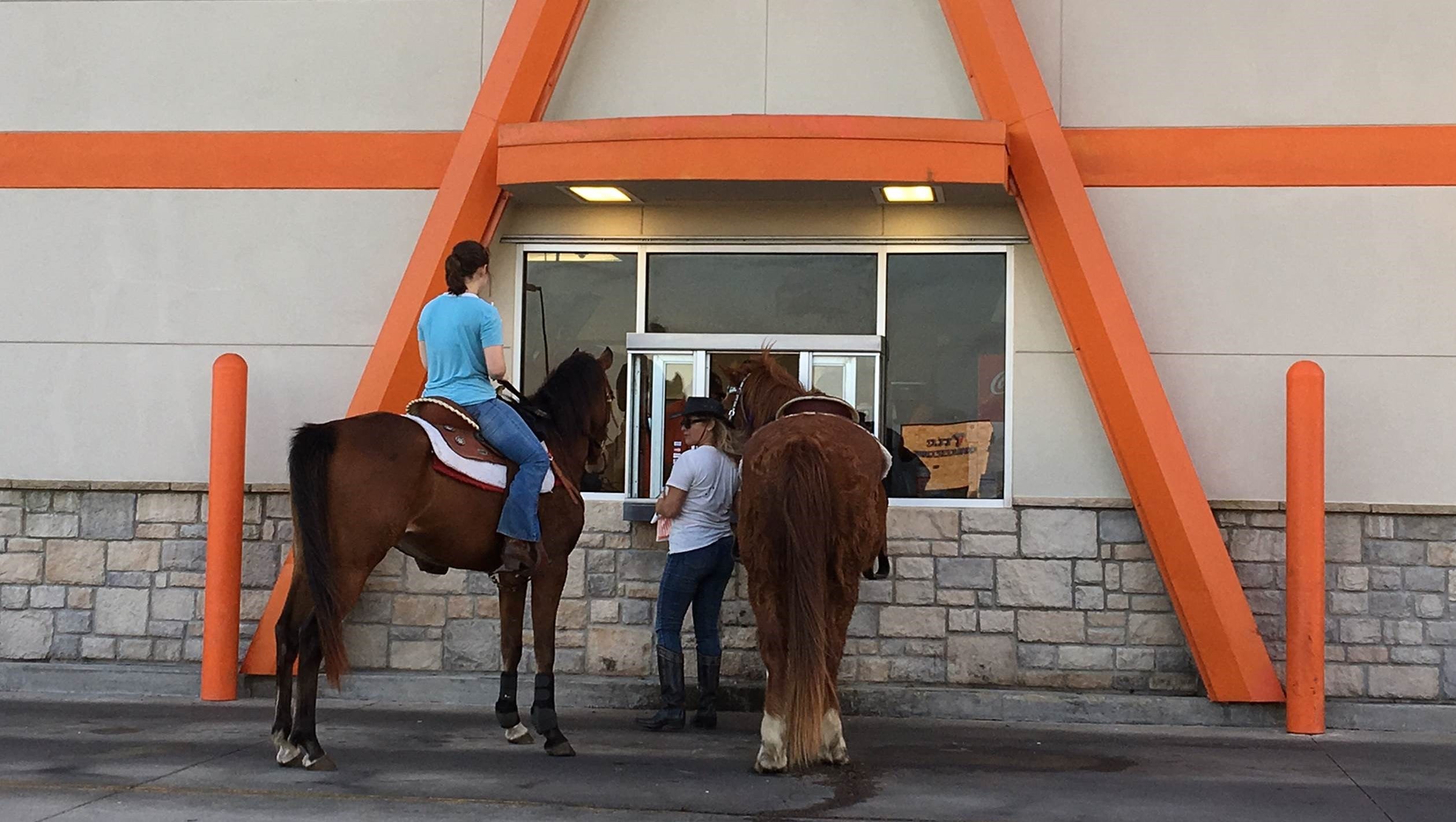 Women order Whataburger on horseback in drivethrough in Corpus Christi