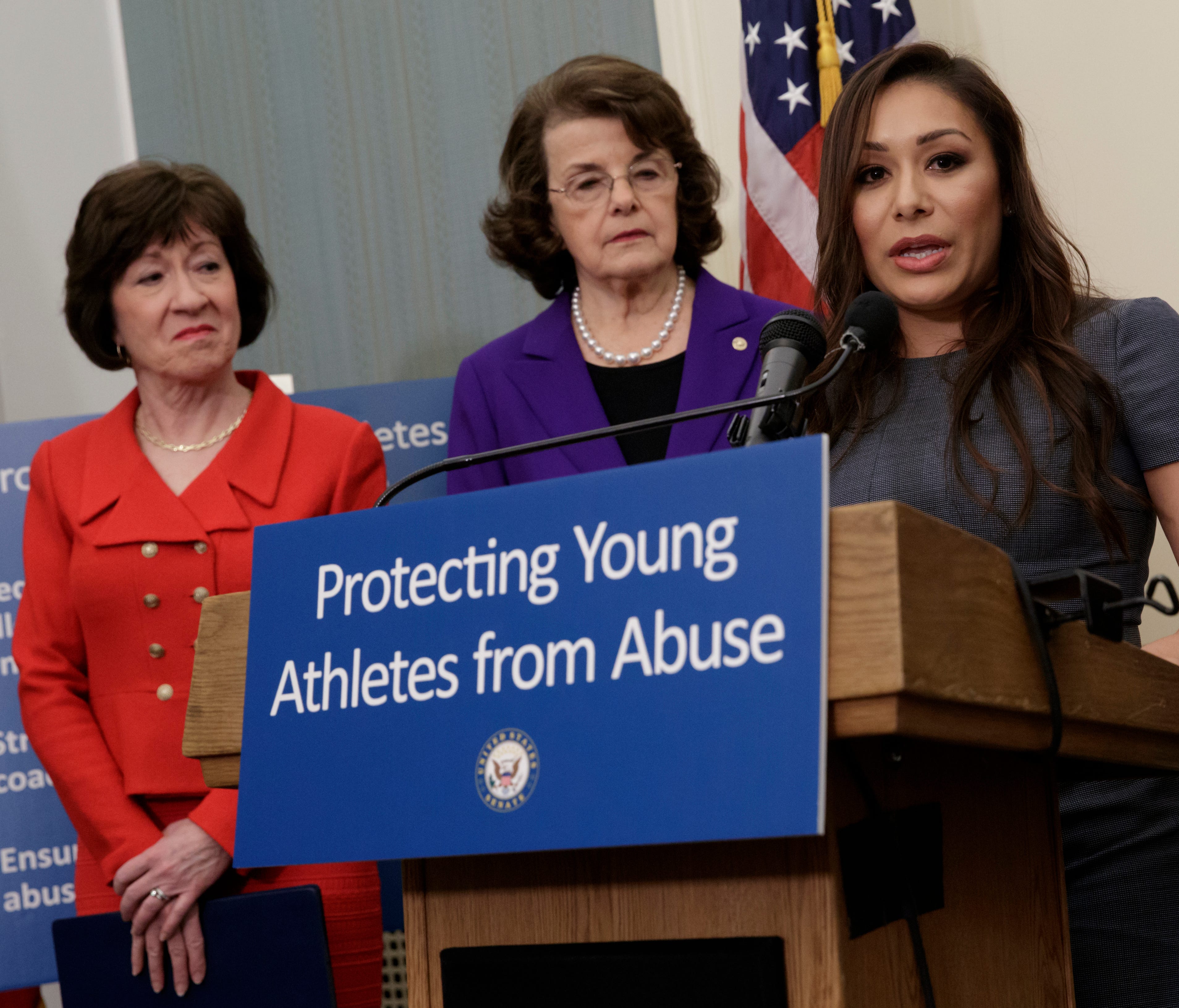 Former gymnast Jeanette Antolin, right, accompanied by Sen. Susan Collins, R-Maine, left, and Sen. Dianne Feinstein, D-Calif., ranking member on the Senate Judiciary Committee, speaks during a news conference on Capitol Hill in Washington on March 28