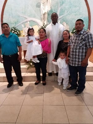 Elizabeth Sebastian, 2, on the day of her baptism with her mother (in pink) and her father (far right). Elizabeth drowned in an Immokalee apartment complex pool.