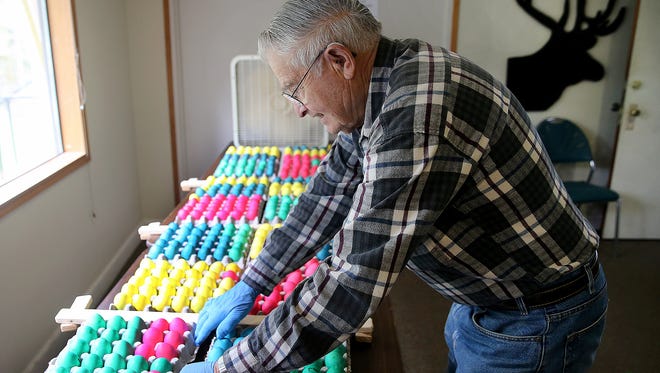 Henry Altenburg puts out finished hard boiled eggs to cool down after being cooked and dyed at the Bremerton Elks Club on Wednesday. Volunteers were cooking 2,000 eggs for the annual Easter egg hunt on Sunday.