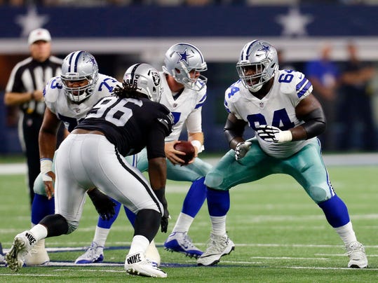 FILE - In this Aug. 26, 2017, file photo, Oakland Raiders' Denico Autry (96) and Dallas Cowboys' Jonathan Cooper (64) face off at the line of scrimmage during a preseason NFL football game in Arlington, Texas. Cooper joined the Cowboys as an afterthought in January when they were preparing for the playoffs. Now the former top 10 pick by Arizona is a starter on a Pro Bowl-laden offensive line that is starting to find last season's form.(AP Photo/Roger Steinman, File)