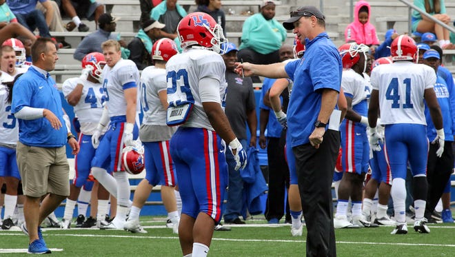 Louisiana Tech coach Skip Holtz discusses a play with running back Jay Gafford during last week's spring game.