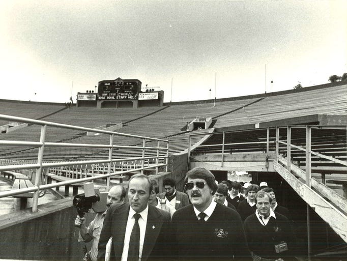 Coach Hayden Fry and his team tour the stadium during