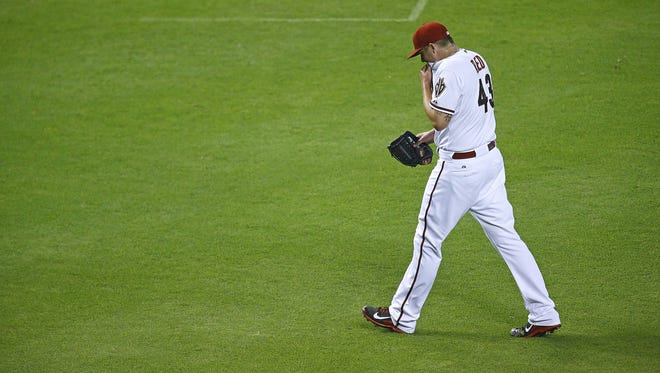 Arizona Diamondbacks relief pitcher Addison Reed (43) following the 9th inning where he gave up a two-run home run to Miami Marlins'  Marcell Ozuna (13) in  their MLB game Tuesday, July 8, 2014 in Phoenix.