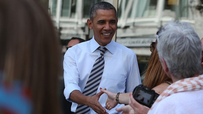 President Obama greets people after picking up lunch at the Taylor Gourmet Deli, on Oct. 4, 2013 in Washington, D.C.