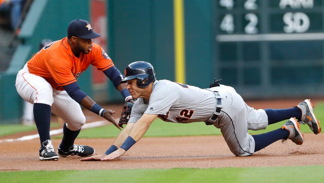Detroit Tigers' Ian Kinsler, right, is tagged out by Houston Astros third baseman Luis Valbuena during the first inning Friday.