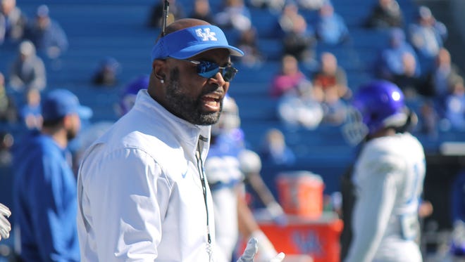 UK wide receivers coach Lamar Thomas shouts instructions during an open practice at Commonwealth Stadium on March 26, 2016.