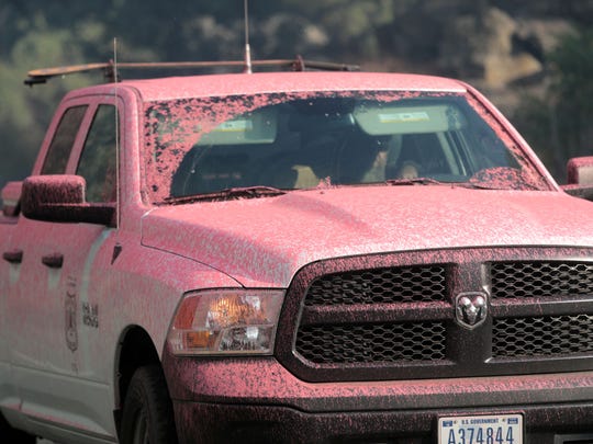 A forest service truck is stained with fire retardant