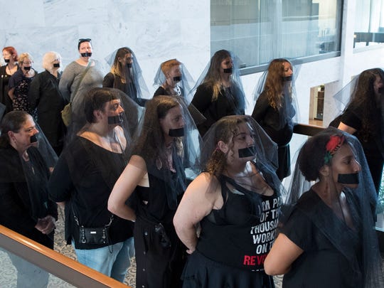Women's reproductive rights activists who oppose the nomination of Judge Brett Kavanaugh to the U.S. Supreme Court wear black veils and tape over their mouths outside the hearing room during the Senate Judiciary Committee's confirmation hearing on Kavanaugh, in Washington, D.C., Sept. 7, 2018. EPA-EFE/MICHAEL REYNOLDS