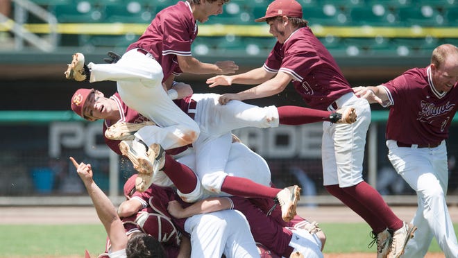 Shoals Christian’s Matthew Durham (15) jumps onto Shoals Christian’s Dale Thomas (20) and Shoals Christian’s Taylor Spinks (4), right, goes to join after winning the AHSAA Class 1A State Championship Game on Wednesday, May 13, 2015, in Montgomery, Ala.