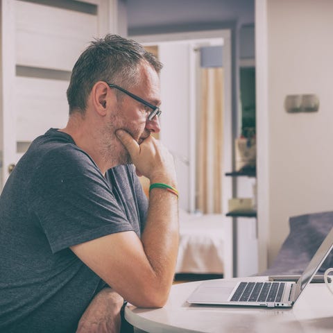 Older person with serious expression sitting in fr