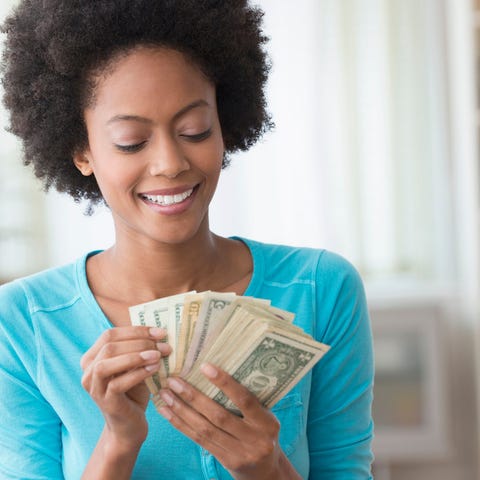 Smiling person counting money