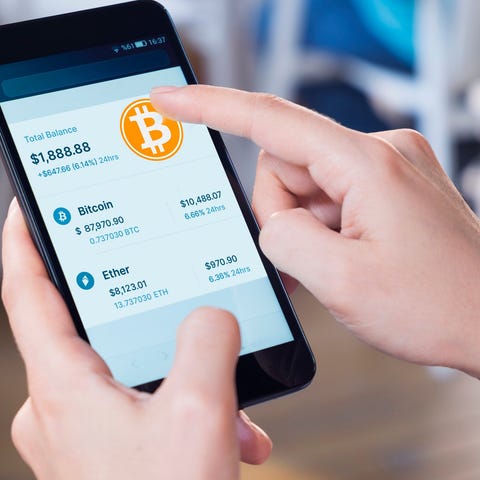 Person trading Bitcoin on a smartphone.