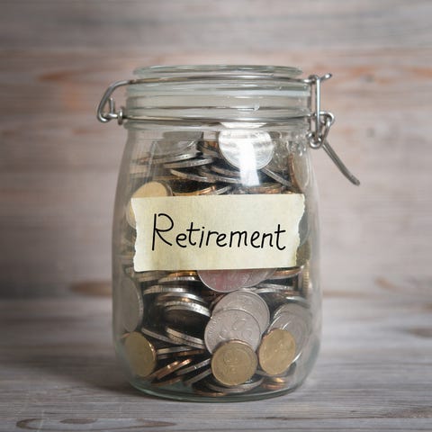 Glass jar with the word retirement on a piece of t