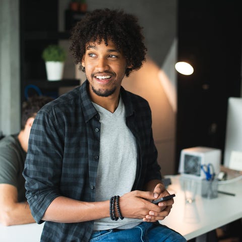 A young person using a smartphone.