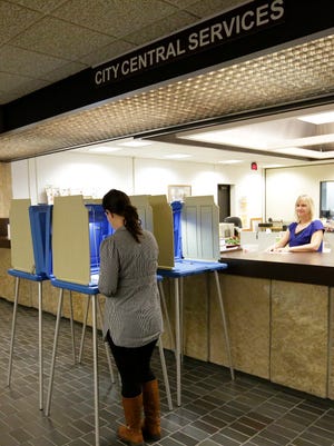 City Clerk Maggie Hefter waits for a voter’s absentee ballot at the City County Government Center in Fond du Lac Thursday September 22, 2016. Doug Raflik/USA TODAY NETWORK-Wisconsin