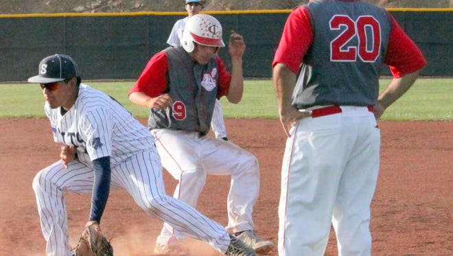 Cobre's Adrian Ortiz gets back to the base on time after Silver's Stephen Grado awaits the throw from the catcher.