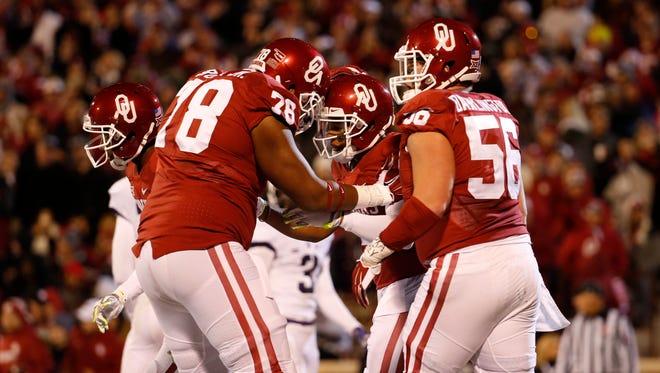 Oklahoma wide receiver Sterling Shepard (3) celebrates with offensive tackle Orlando Brown (78) and center Ty Darlington (56) after catching a touchdown pass against TCU on Nov. 21.