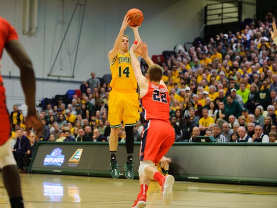 Vermont's Cam Ward (14) shoots a three pointer during
