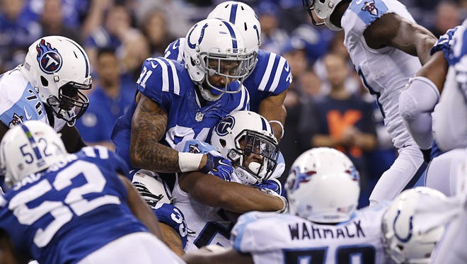 Indianapolis Colts outside linebacker Jonathan Newsome (91) pushes Tennessee Titans running back David Cobb (23) back on a third and short at Lucas Oil Stadium on Jan. 3, 2016.