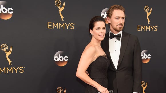   Neve Campbell (L) and JJ Feild attend the 68th Primetime 
