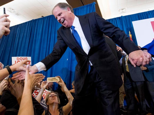 Doug Jones greets supporters as he claims victory at
