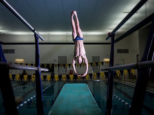 Delta's Sam Bennett practices for the diving state championships at Delta High School Wednesday, Feb. 21, 2018. 