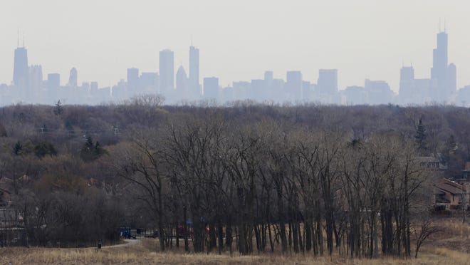 In this March 19, 2015, file photo, a thick haze of smog looms over the skyline of Chicago.