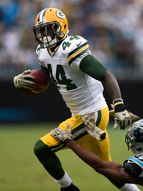 Green Bay Packers running back James Starks (44) tries to elude Carolina Panthers cornerback Josh Norman (24) during Sunday's game at Bank of America Stadium in Charlotte, N.C.