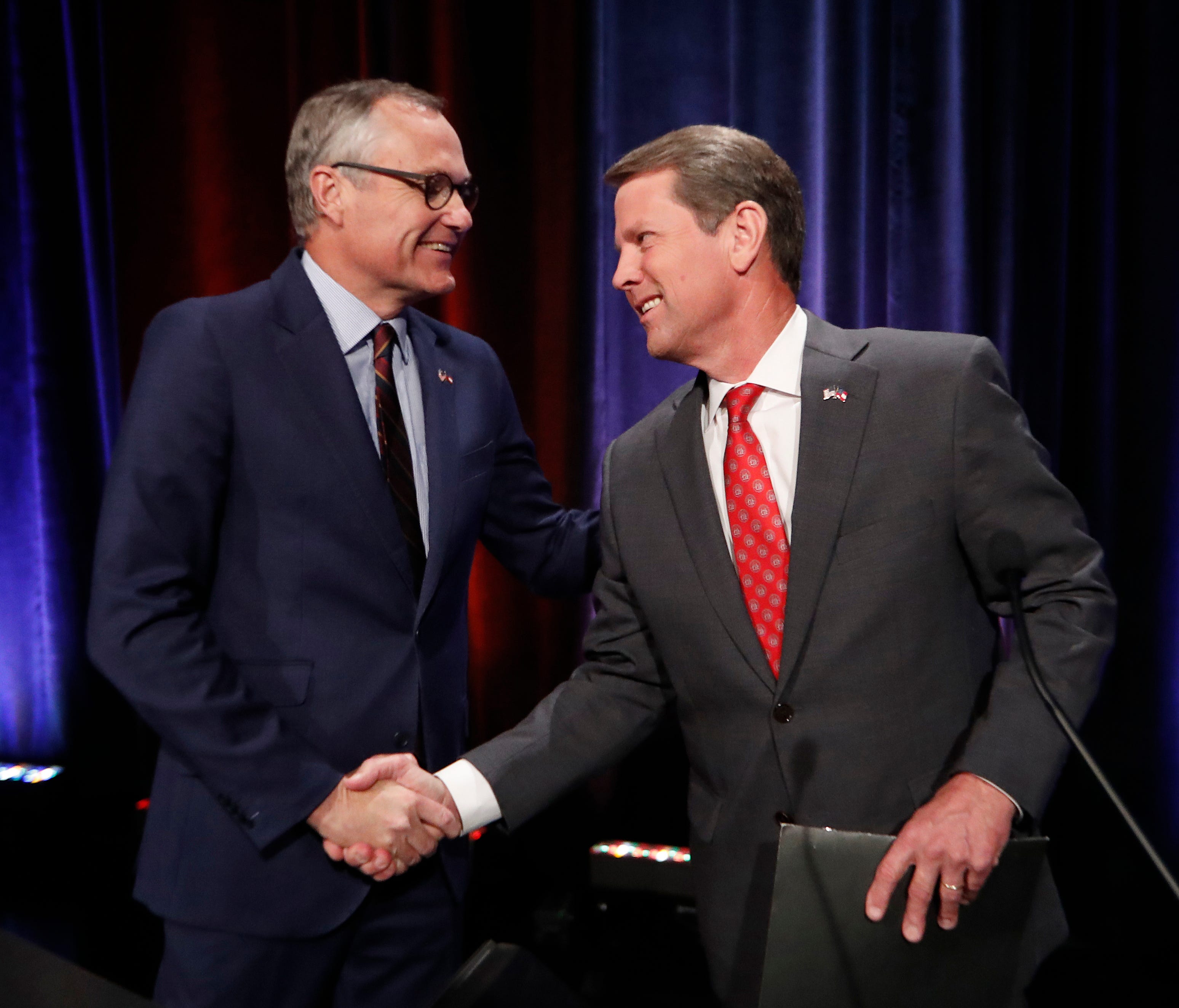 In this July 12, 2018, file photo, Republican candidates for Georgia governor, Lt. Gov. Casey Cagle, left, and Secretary of State Brian Kemp. shake hands after an Atlanta Press Club debate at Georgia Public Television in Atlanta. The two will face ea