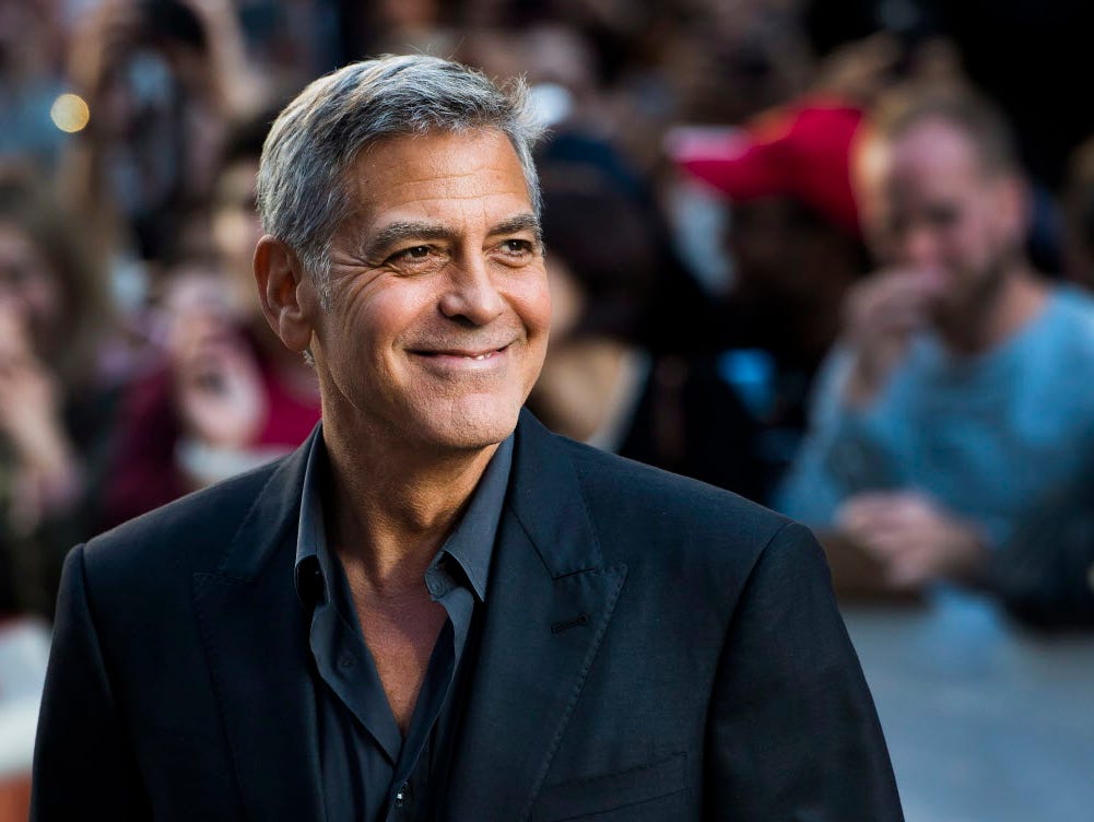 Director and actor George Clooney arrives on the red carpet for the movie 