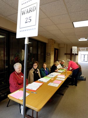 Poll workers wait to help voters cast their ballots for the 25th and 26th wards at Bethany Reformed Church Feb. 21, 2017, in Sheboygan.