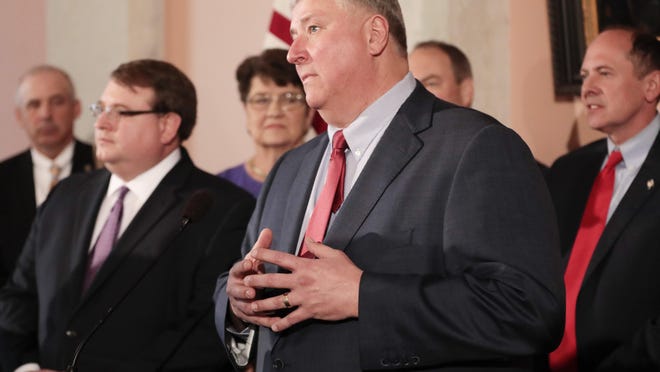 Ohio House Speaker Larry Householder, center -- seen here speaking to the media following Gov. Mike DeWine's first State of the State address on Tuesday, March 5, 2019 at the Ohio Statehouse -- has been indicted along with four associates on federal racketeering and bribery charges related to a bill that bailed out the state's nuclear power plants.