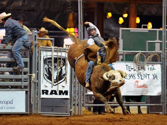 A bull rider hangs on tight at the Roots N' Boots festival
