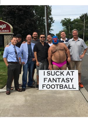 The now-famous Angelo Boemio (shirtless) poses with fellow members of his fantasy football league in Toms River.