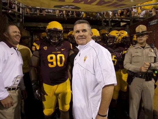 Todd Graham looks out at the field before his coaching