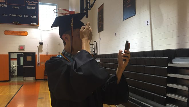 Jack Rusk adjusts his cap in the gymnasium before Marlboro High School's graduation on Friday.