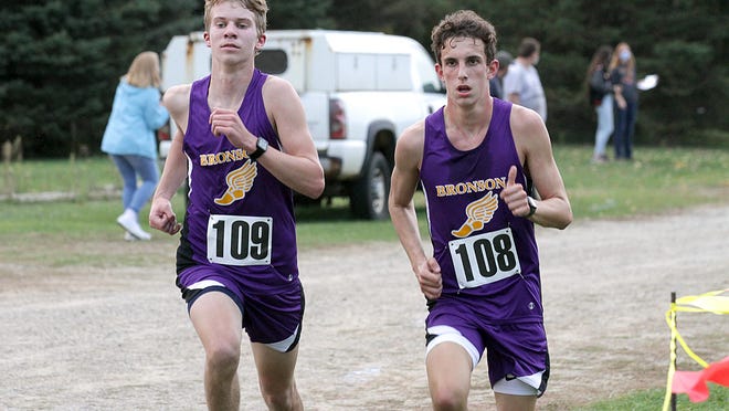 Tanner Norton and Brayden Ransbottom run in the final portion of Monday's cross country matchup between Bronson and Quincy.